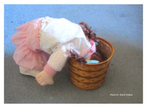 Doll looks in basket 
